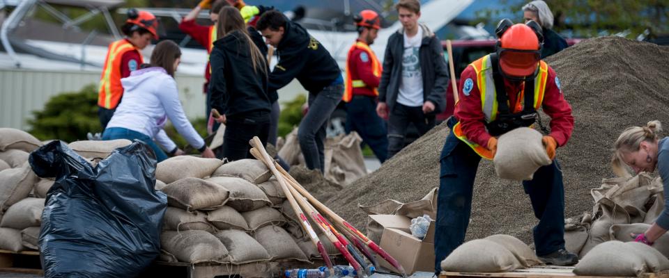 Relief workers prepare sandbags in the Okanagan