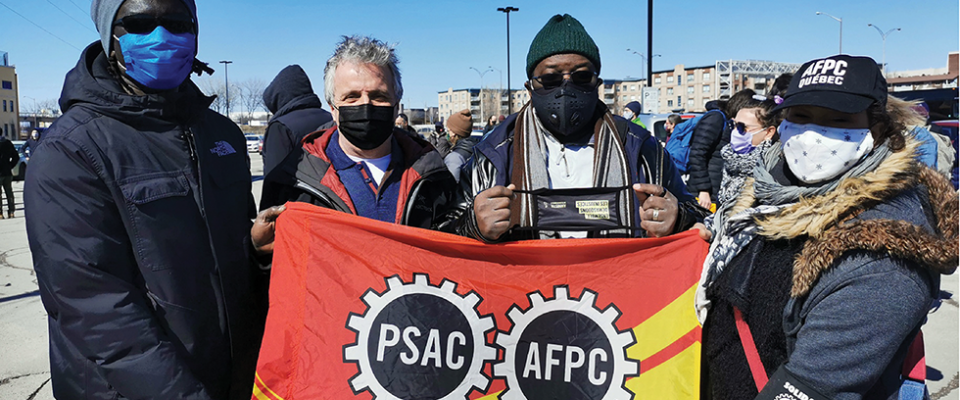 Mamadou Ndaye, PSAC Quebec REVP Yvon Barrière, Djimy Théodore and Kenza El Azzouzi march at an anti-racism rally in Quebec.