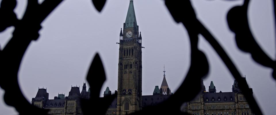Photo of Parliament Hill through an iron fence
