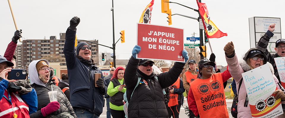 A group of PSAC members cheering at a rally during the 2023 strike