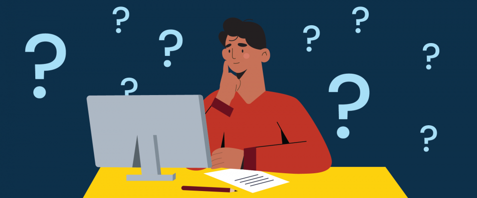 Man sitting at a computer surrounded by question marks.