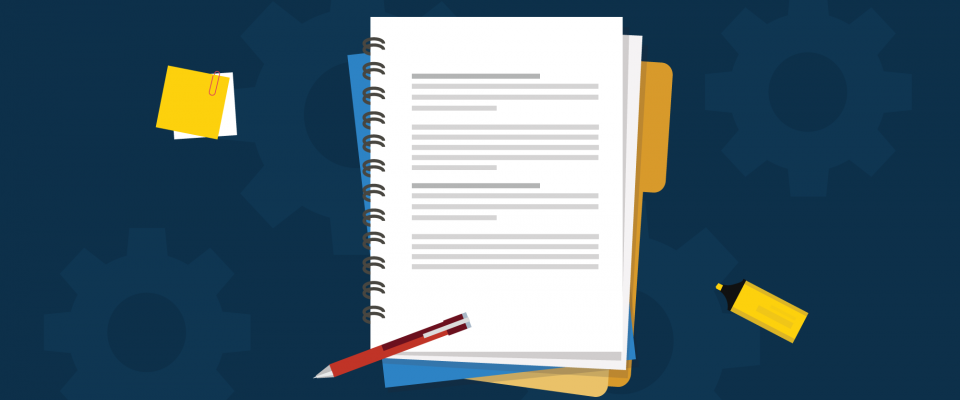 Notebook, pen, and post-its on a navy background.