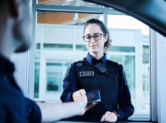 Border agent taking passport