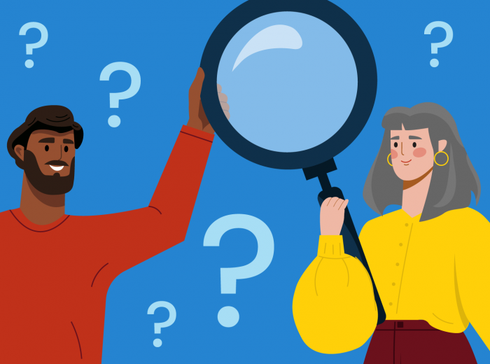 Two people holding a magnifying glass in front of a collage of question marks