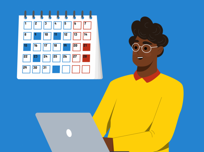 Figure in yellow in front of laptop and calendar 