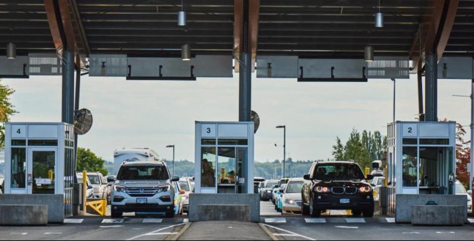 Border crossing photo Several cars stopped at a US/Canada border crossing.