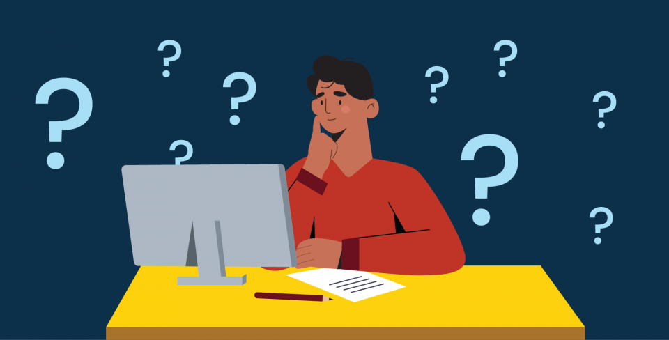 Man sitting at a computer surrounded by question marks.