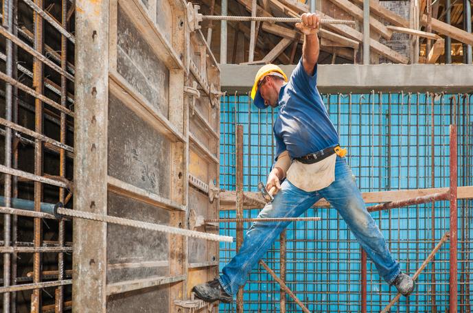 Construction worker balanced precariously